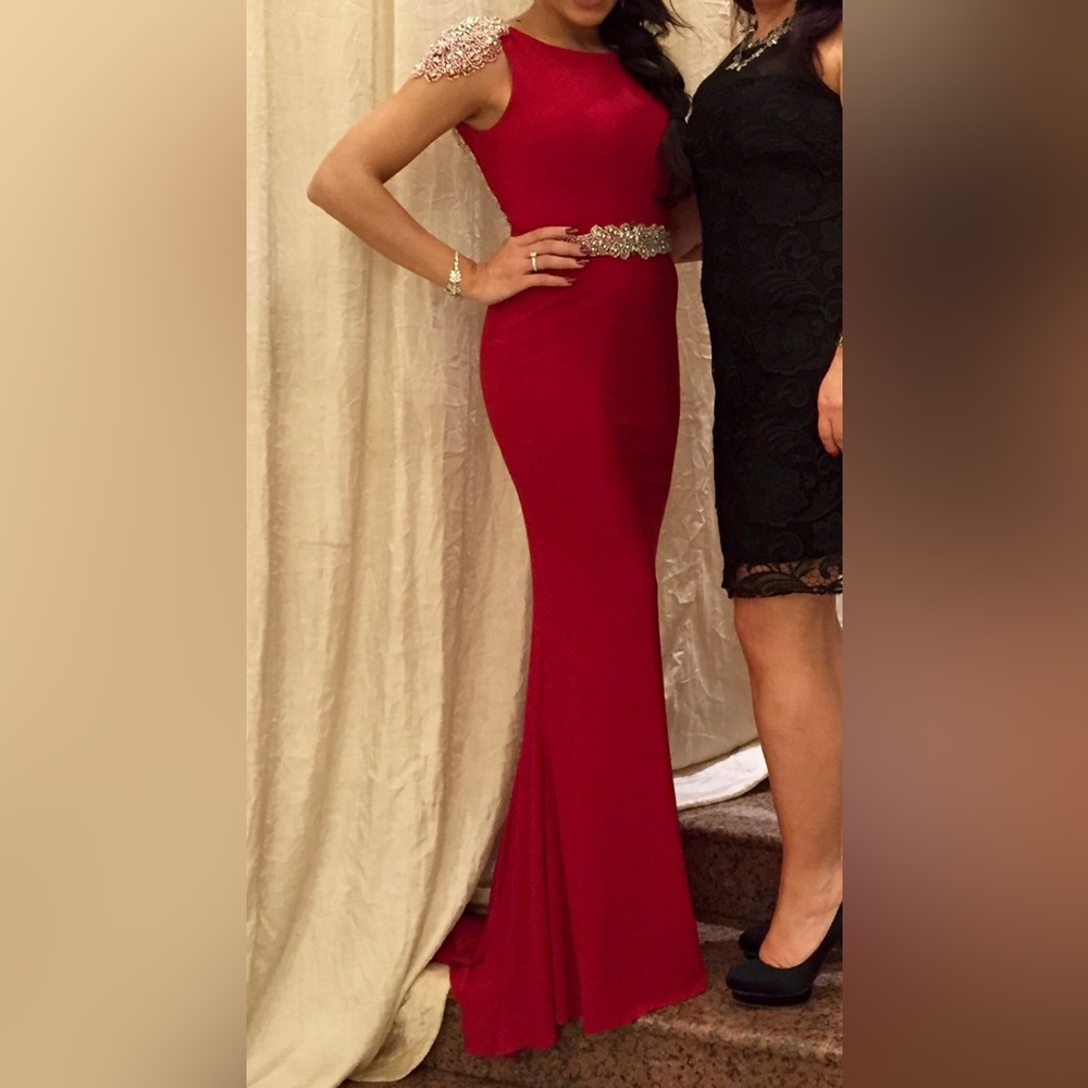 Red gown with silver sequin detailing on shoulders and semi low back. Mini train